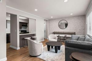 a living room with a couch and a table at Newly Renovated Unit in Central Spfld #203 in Springfield
