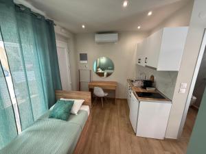 a small kitchen with a couch in a room at ΑVLI Superior Studio Sarti no6 in Sarti