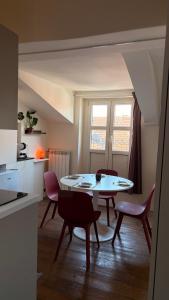 a kitchen and dining room with a table and chairs at Asterisco Casa Vacanze in Turin