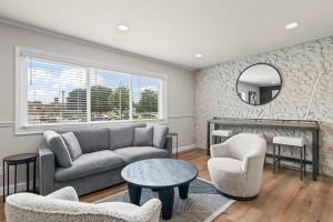 a living room with a couch and chairs and a fireplace at Newly Renovated Unit in Central Spfld #204 in Springfield
