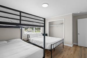 a bedroom with two bunk beds and a window at Newly Renovated Unit in Central Spfld #204 in Springfield