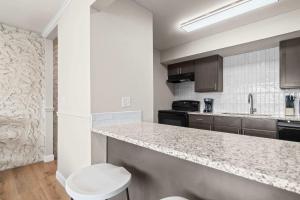 a kitchen with a counter and a toilet in it at Newly Renovated Unit in Central Spfld #204 in Springfield +9 photos