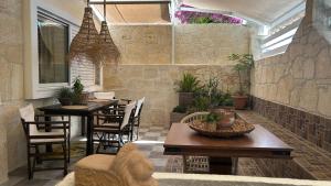 a patio with two tables and chairs and plants at Hospitality M7 in Kallithea Halkidikis
