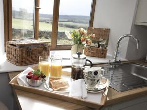 a tray of breakfast food on a kitchen counter with a window at 1 Bed in Ripon oc-g0023 in Winksley