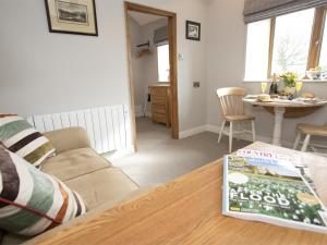 a living room with a couch and a table at 1 Bed in Ripon oc-g0023 in Winksley +6 photos