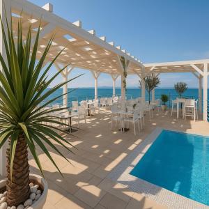 a patio with a table and chairs and a pool at Sunny resort apartment with pool access in Zadar