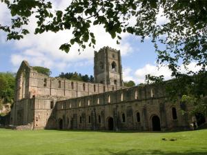 an old castle with a tower and a grass field at 1 Bed in Ripon oc-g0023 in Winksley