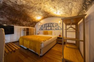 a bedroom with a bed and a brick wall at Solar de Arrayollos by PURUS in Arraiolos +46 photos
