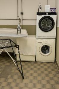 a laundry room with a washer and a washing machine at Bright Lake View Apartment with Balcony and Air Conditioning in Tutzing