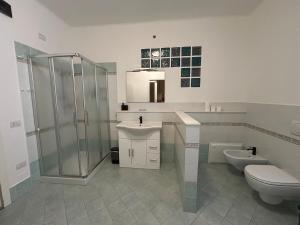 a bathroom with a shower and a toilet and a sink at Affittacamere VITRUVIO in Fano