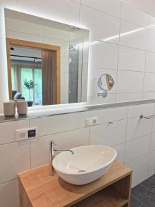 a bathroom with a white sink and a mirror at Lieblingsplatz Alpine Lodge in Tschagguns +26 photos