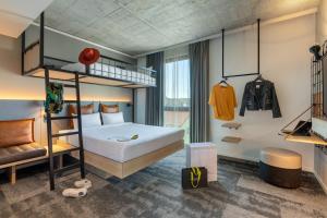a bedroom with a bed and a bunk bed at Moxy Outletcity Metzingen in Metzingen