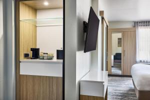a hotel room with a bed and a tv at SpringHill Suites by Marriott Chesterfield in Chesterfield