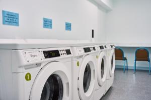 a row of washing machines in a laundry room at SpringHill Suites by Marriott Chesterfield in Chesterfield