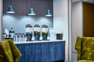 a counter with four coffee machines on it in a room at SpringHill Suites by Marriott Chesterfield in Chesterfield