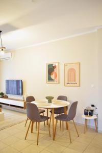 a dining room with a table and chairs at Emmeleia Urban Apartment in Xanthi
