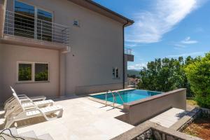 a villa with a swimming pool and a house at Villa Manuela in Opatija