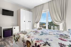 a bedroom with a bed with a floral bedspread at Villa Manuela in Opatija +12 photos