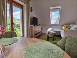 a living room with a table and a couch at Salvia Guesthouse Balatonfüred in Balatonfüred