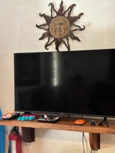 a flat screen tv sitting on top of a wooden table at Centric, clean, safe, with pool & monkey visitors in Tamarindo