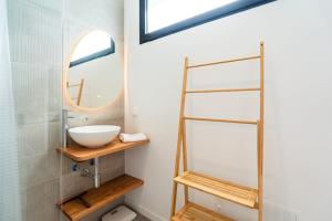a bathroom with a sink and a mirror at GuestReady – Steps from Sand • Champagne Pool in Machico +16 photos