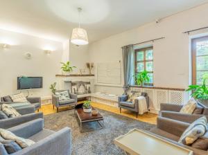 a living room with couches and a tv at Golden Villas Luxury Garden Retreat - Jacuzzi & Sauna in Konstancin-Jeziorna