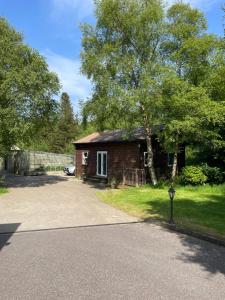 a small house with a tree and a driveway at Studio in Letterkenny