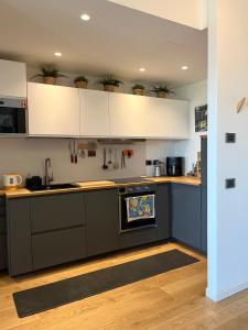 a kitchen with black counters and white cabinets at 081 Art corner - Milano ovest in Abbiategrasso