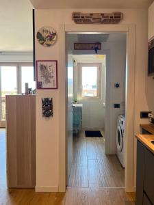 a kitchen with a door open to a laundry room at 081 Art corner - Milano ovest in Abbiategrasso