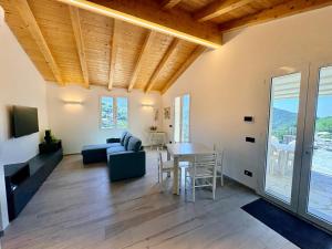 a living room with a table and a couch and a dining room at House Over The Paradise in Moneglia