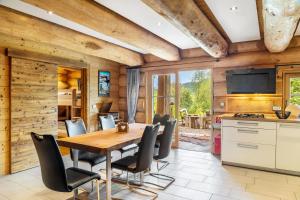 a kitchen and dining room with a wooden table and chairs at Chalet Weiss in Wörgl