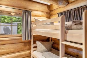 a bedroom with two bunk beds in a log cabin at Chalet Weiss in Wörgl