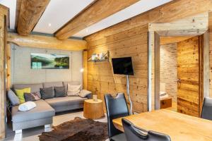 a living room with a couch and a table at Chalet Weiss in Wörgl