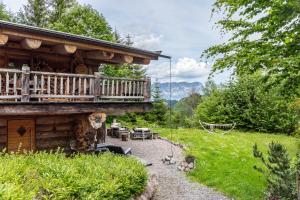 a log cabin with a porch and a deck at Chalet Weiss in Wörgl