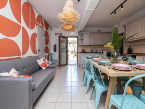 a dining room with a long table and blue chairs at Villa Ada in Faro