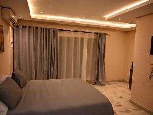 a bedroom with a bed and a window with curtains at Gae Ga Monare Guest House in Burgersfort