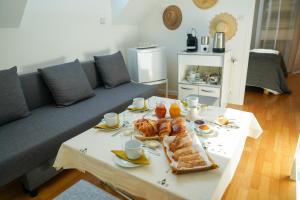 a living room with a table with food on it at Chambre d'hôtes près du Château in Sully-sur-Loire
