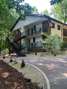 a building with a staircase in front of a road at Skorzęcin Apartamenty Orla in Skorzęcin