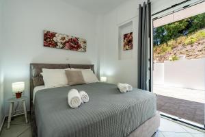 a bedroom with a bed with towels on it at Aspasia Studios in Lixouri +63 photos