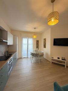 a kitchen with a table and a dining room at Modern Sea Apartment in Punta Marina