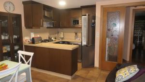 a kitchen with a sink and a refrigerator at Casa Leo in Cee +11 photos