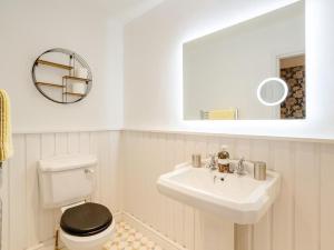 a bathroom with a sink and a toilet and a mirror at 1 Bed in York oc-91888 in Full Sutton