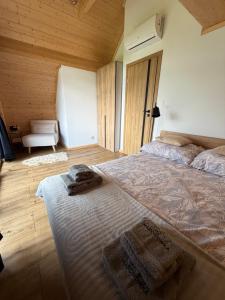 a bedroom with a large bed with towels on it at Marcinówka - Górski Domek w Gorcach in Tylmanowa