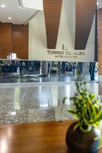 a lobby with a vase with a plant on a table at Torres de Alba Hotel & Suites in Panama City +28 photos