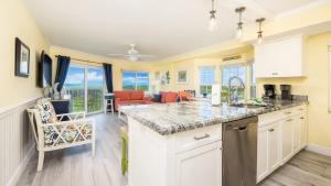 a kitchen with a counter top and a living room at Sunrise Penthouse 3316 Ocean Pointe 1BR 2BA in Tavernier