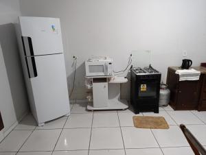 a kitchen with a refrigerator and a stove at Casa indaial in Indaial