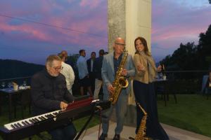 a man playing a saxophone next to a woman at Hotel Montallegro in Rapallo