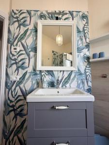 a bathroom with a sink and a mirror at Modern Sea Apartment in Punta Marina +7 photos