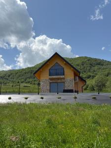 a log cabin with a mountain in the background at Marcinówka - Górski Domek w Gorcach in Tylmanowa