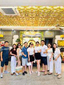 a group of people standing in front of a store at SALA HOTEL HUE in Hue